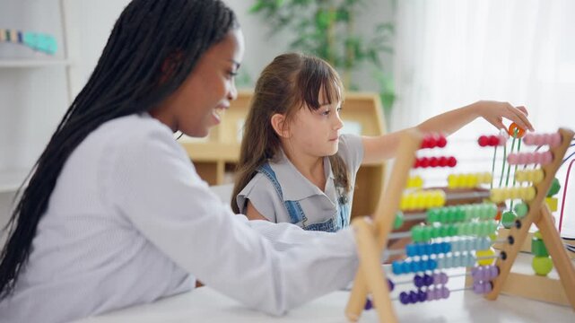 African tutor use educational toy help little child learn basic skills. 
