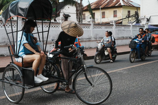 Luang Prabang, May 2026 

Groups of people ride through the old streets on cyclo, passing rows of weathered colonial buildings, quiet caf&eacute;s, and travelers wandering by with their cameras. 