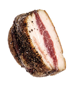 Cured guanciale pork cheek coated in cracked pepper, isolated on white background