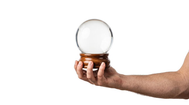 Hand holding empty glass crystal ball on wooden stand