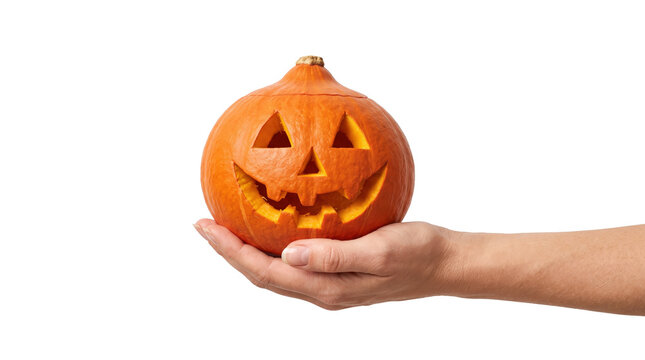 Hand holding a carved orange halloween pumpkin jack-o-lantern