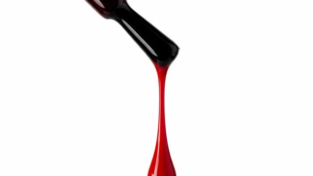 Red Nail Polish Dripping from Brush on White Background