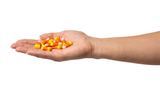 Hand holding colorful candy corn sweets