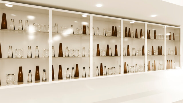 Glass and brown decorative vases arranged on white display shelf