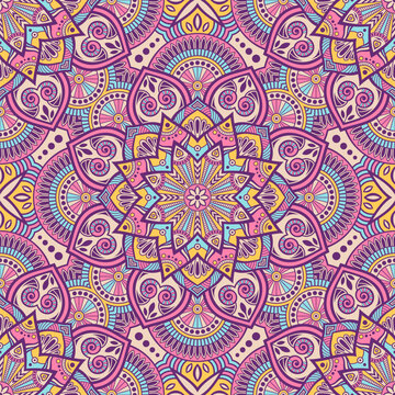 Colorful seamless mandala vector pattern with ornate paisley and heart motifs, boho floral geometry and vibrant symmetry. Perfect for wallpapers, textiles, wrapping paper, yoga and festival designs.