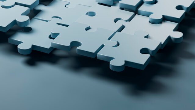 Blue 3d puzzle pieces fitting together in close-up