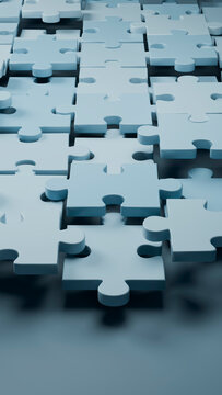 Blue interlocking jigsaw puzzle pieces in a 3d illustration