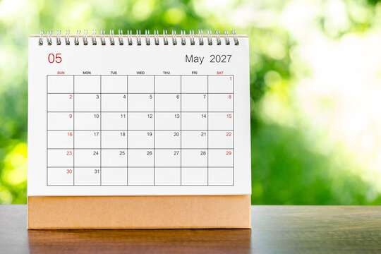 May 2027 Calendar desk for organizer to plan and reminder on wooden table.
