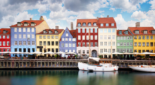Colorful traditional houses in the Old port of Nyhavn in Copenhagen, Denmark. Nyhavn port is a popular travel destination and main landmark of Copenhagen city