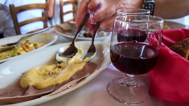 Traditional Vitello Tonnato Served with Red Wine at Italian Restaurant