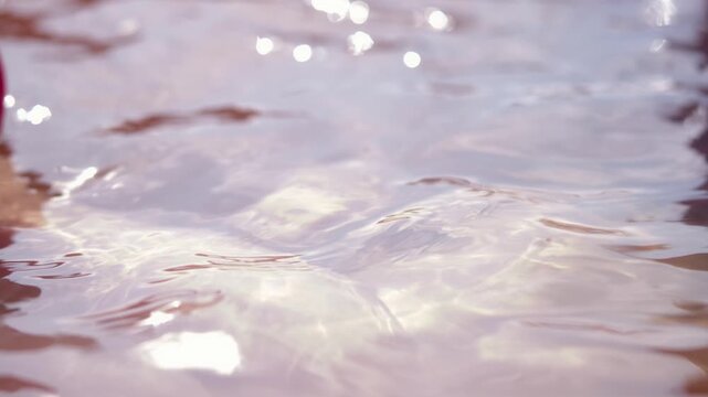Water ripples reflect sunlight in a sauna on a warm summer day