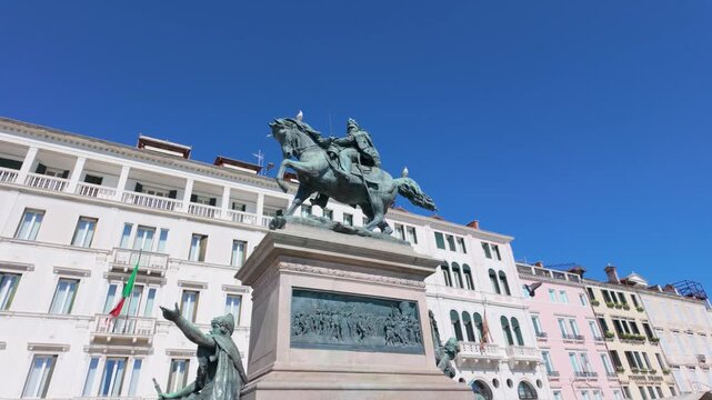 Equestrian monument rising before ornate historic palazzi