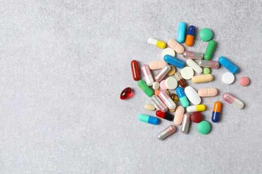 Various medical pills on light background