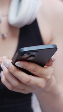 woman holds smart phone in her hands and scrolls through the news feed. Close up of hand uses mobile. point finger on screen, texting text message.