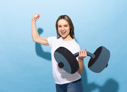 Athlete flexing arm with paper dumbbell on blue background