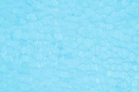 Detailed background texture of light blue expanded polystyrene foam block with soft granular cell structure for packaging or insulation mockup