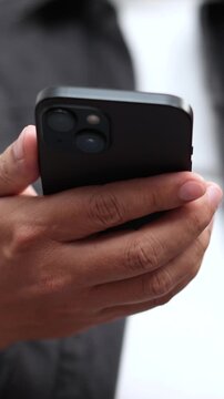 man holds smart phone in her hands and scrolls through the news feed. Close up of hand uses mobile. point finger on screen, texting text message.