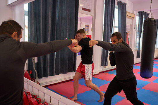 Kickboxers shadowboxing in front of mirror