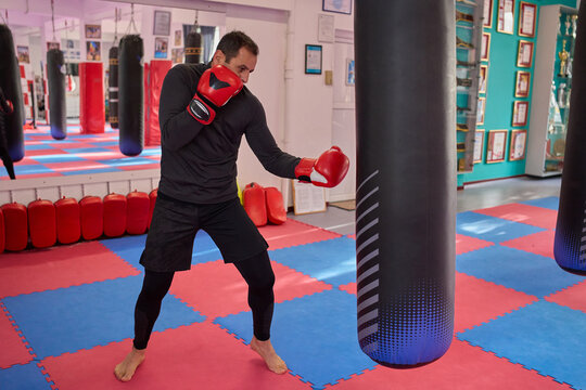 Man throwing uppercut at punching bag