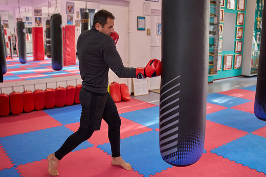 Man throwing uppercut at punching bag