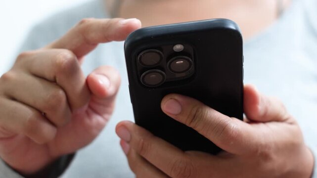 woman holds smart phone in her hands and scrolls through the news feed. Close up of hand uses mobile. point finger on screen, texting text message.