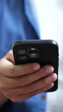 man holds smart phone in her hands and scrolls through the news feed. Close up of hand uses mobile. point finger on screen, texting text message.