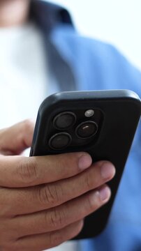 man holds smart phone in her hands and scrolls through the news feed. Close up of hand uses mobile. point finger on screen, texting text message.