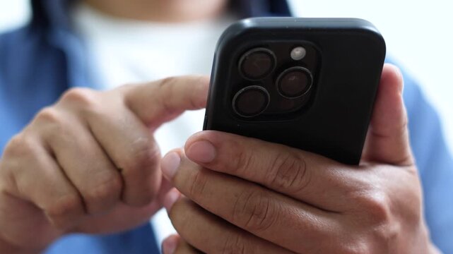man holds smart phone in her hands and scrolls through the news feed. Close up of hand uses mobile. point finger on screen, texting text message.