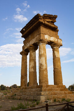  Agrigento, Italy - 08.22.2024: Famous four-column monument known as the Temple of Castor and Pollux at sunset light in Agrigento.

