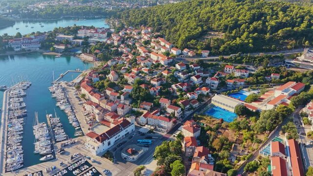 Drone Aerial of Korcula Old Town Harbor, Red Roofs and Coastal Bay, Croatia