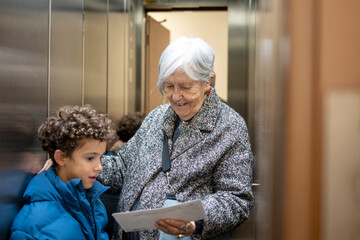 Grandmother and grandson sharing a loving moment in elevator © GREGORIO