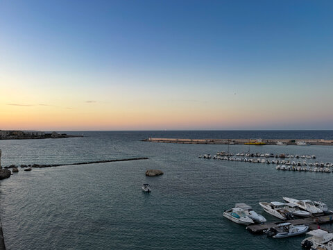 Beautiful scenic view of the ancient fortified historic center of Otranto with white houses overlooking the crystal clear turquoise Adriatic sea. Famous travel destination in Salento, Apulia, Southern
