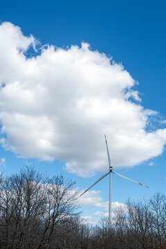 Wind turbines in Istanbul. A wind power plant (wind turbines) situated in a vast rural area is visible. In the foreground, there is a wide expanse of land covered with dry grass, shrubs 