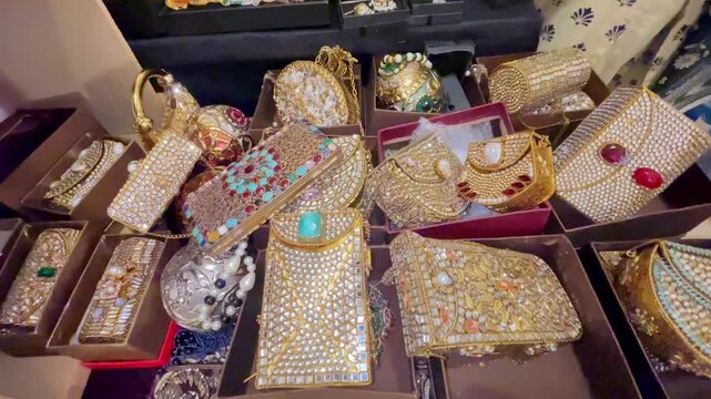 Close-up view of traditional Pakistani fashion jewelry, embellished clutches, bracelets, decorative purses, and colorful accessories displayed at a local handicraft market.