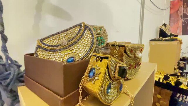 Close-up view of traditional Pakistani embellished clutch bags and decorative purses featuring colorful stones, beads, pearl details, and intricate handcrafted designs.