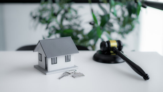 House model, home key and judge gavel symbolize real estate law, property ownership, legal rights, home purchase contracts, mortgage disputes and professional residential legal services.