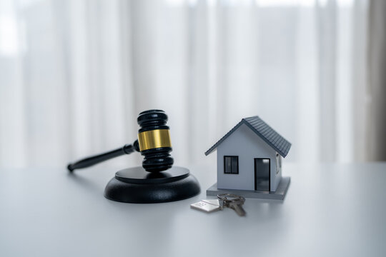 Judge gavel, house model and home keys represent real estate law, property rights, home ownership, mortgage disputes, legal protection and residential property transactions.