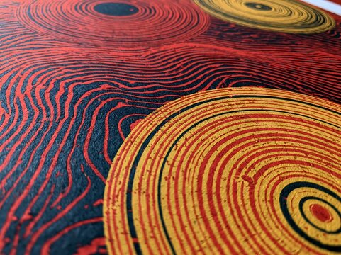 アボリジニアートやトライブの幾何学模様を彷彿とさせる、年輪と流線が美しいエスニック調の抽象背景