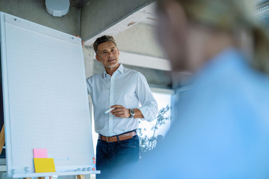 Businessman explains startup vision to woman at the office
