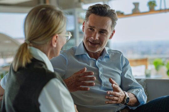Man and woman discussing a contract in the office