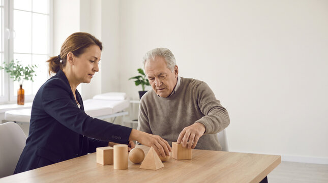 Neurologist conducts cognitive assessment with senior patient using geometric objects to evaluate memory, attention and thinking skills during neurological examination.