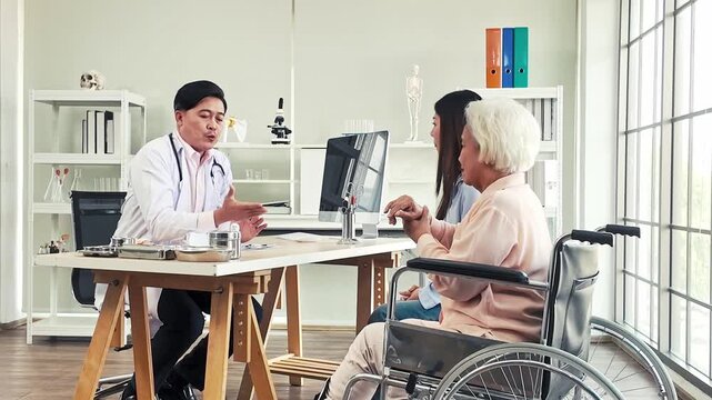 Doctor consults an elderly wheelchair user with a family member in a bright clinic office, discussing diagnosis and care plan.