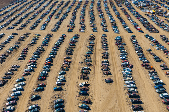 Aerial view of rows of discarded and damaged vehicles at an automobile salvage and recycling facility in Dacono, Colorado, United States.