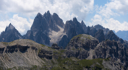 Naklejka premium Mountain landscape panorama Tre Cime Mount against a blue summer background. 