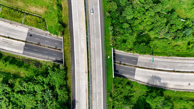 Aerial view of the Soreang highway interchange with concrete roads and lush green vegetation in Bandung, West Java, Indonesia.