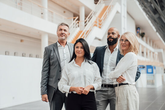 Business team stands together in a modern office lobby
