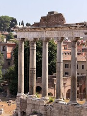 Ancient Temple of Saturn with tall Ionic columns and Latin inscription in the Roman Forum, Rome, Italy. Historic Roman architecture, archaeological ruins and cultural heritage in daylight. © Yana Perelotova