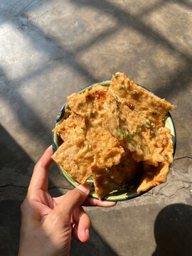 hand holding a bowl with tempe