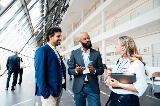 Colleagues discuss business at a trade fair