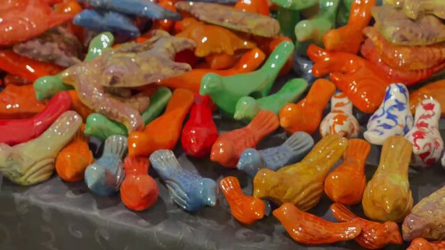 Handcrafted Glazed Ceramic Figures and Pottery Souvenirs Displayed at Craft Market